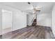 Living room with laminate flooring and view to a small staircase, offering a functional space with neutral paint at 46 Hawkins Store Nw Rd, Kennesaw, GA 30144
