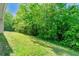 A lush green backyard offers privacy and plenty of space for outdoor activities at 6687 Hill Creek Cv, Lithonia, GA 30058