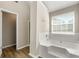 Bright bathroom featuring a soaking tub, wood look flooring, and shower in the Primary suite at 6687 Hill Creek Cv, Lithonia, GA 30058