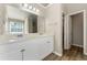 Bathroom featuring double sink vanity with white cabinets and walk in shower at 6687 Hill Creek Cv, Lithonia, GA 30058