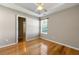 Bedroom with neutral paint and wood floors, open to the bathroom with lots of natural light at 6687 Hill Creek Cv, Lithonia, GA 30058