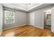 Bedroom with hardwood floors, natural light, and ensuite bathroom at 6687 Hill Creek Cv, Lithonia, GA 30058