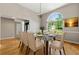 Light and airy dining room with a glass-top table and modern chandelier at 6687 Hill Creek Cv, Lithonia, GA 30058