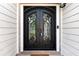 Close-up of a decorative front door with intricate ironwork at 6687 Hill Creek Cv, Lithonia, GA 30058