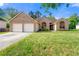 Charming brick home featuring a two-car garage and well-maintained lawn at 6687 Hill Creek Cv, Lithonia, GA 30058