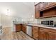 Well-equipped kitchen featuring dark wood cabinets, stainless steel appliances, and granite countertops at 6687 Hill Creek Cv, Lithonia, GA 30058