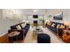 Spacious living room featuring modern sofas, fireplace, and stylish decor at 6687 Hill Creek Cv, Lithonia, GA 30058