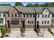 Aerial view showcasing the desirable townhome community with well-maintained exteriors and landscaping at 243 Commons Ave, Woodstock, GA 30188