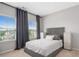 Cozy bedroom featuring large windows for natural light, neutral color scheme, and minimalistic furniture at 243 Commons Ave, Woodstock, GA 30188