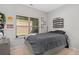 Serene bedroom with large window, neutral tones, a gray comforter, and decorative wall art at 243 Commons Ave, Woodstock, GA 30188