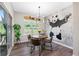 Bright dining area with modern light fixture and view to outdoor area at 243 Commons Ave, Woodstock, GA 30188