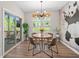 Charming dining area with modern light fixture, leading to the outdoor patio at 243 Commons Ave, Woodstock, GA 30188