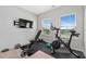 Home exercise room featuring workout equipment, TV, and natural light from large windows for an active lifestyle at 243 Commons Ave, Woodstock, GA 30188