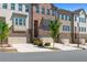 Attractive townhomes featuring brick exteriors, private garages, and manicured landscaping at 243 Commons Ave, Woodstock, GA 30188