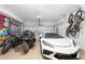 Organized garage featuring ample storage, multiple vehicles, and space for hobbies or projects at 243 Commons Ave, Woodstock, GA 30188