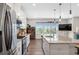 Bright kitchen with stainless steel appliances, granite countertops, island, and hardwood floors at 243 Commons Ave, Woodstock, GA 30188