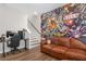 Inviting living room featuring a tattoo themed accent wall, hardwood floors, and comfortable seating at 243 Commons Ave, Woodstock, GA 30188