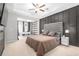Relaxing main bedroom, features a ceiling fan, a comfortable bed, and large windows at 243 Commons Ave, Woodstock, GA 30188