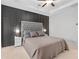 Serene main bedroom boasts a tufted headboard, soft lighting, and cozy bedding at 243 Commons Ave, Woodstock, GA 30188
