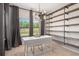 Home office boasts built-in shelves, an atomic chandelier, and a large window for natural light at 243 Commons Ave, Woodstock, GA 30188