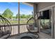 Comfortable patio with modern egg chair, outdoor TV, and tranquil backyard views at 243 Commons Ave, Woodstock, GA 30188