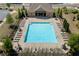 Aerial view of a sparkling community pool with lounge chairs at 243 Commons Ave, Woodstock, GA 30188