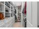 Organized walk-in closet with custom shelving and drawers, providing ample storage space for clothes and accessories at 243 Commons Ave, Woodstock, GA 30188