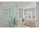 Spa-like bathroom with a glass enclosed shower and freestanding soaking tub near a window at 3475 Oak Valley Rd # 130, Atlanta, GA 30326