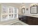 Bright bathroom with double vanity, marble countertops, and large window with sunlight at 3475 Oak Valley Rd # 130, Atlanta, GA 30326