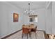 Elegant dining area with a modern chandelier, decorative art, and a stylish table set for dinner at 3475 Oak Valley Rd # 130, Atlanta, GA 30326