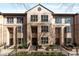 Attractive townhome complex featuring well-maintained landscaping, stately entrances, and brick staircases at 3475 Oak Valley Rd # 130, Atlanta, GA 30326