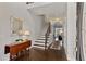 Inviting home foyer with hardwood floors, stairs, and a stylish mirror over a decorative table at 3475 Oak Valley Rd # 130, Atlanta, GA 30326