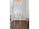 Grand foyer with soaring ceilings, beautiful hardwood floors, a decorative door and transom, and a stylish mirror at 3475 Oak Valley Rd # 130, Atlanta, GA 30326