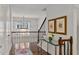 Upstairs hallway with hardwood floors, stairway and chandelier lighting at 3475 Oak Valley Rd # 130, Atlanta, GA 30326