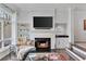 Elegant living room featuring a fireplace, built-in shelving, and natural light at 3475 Oak Valley Rd # 130, Atlanta, GA 30326