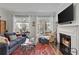 Bright living room with fireplace, hardwood floors, and large windows at 3475 Oak Valley Rd # 130, Atlanta, GA 30326