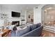 Open-concept living room with fireplace, wet bar, and access to other areas at 3475 Oak Valley Rd # 130, Atlanta, GA 30326