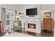 Cozy living room with fireplace, wooden floors, natural light, and a modern TV at 3475 Oak Valley Rd # 130, Atlanta, GA 30326