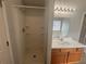 Bathroom featuring a walk-in shower and vanity with oak cabinets at 4884 Browns Mill Ferry Rd, Lithonia, GA 30038