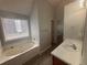 Bathroom featuring a bathtub, single sink vanity, and neutral wall color at 4884 Browns Mill Ferry Rd, Lithonia, GA 30038