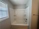 Updated bathroom features a shower and tub combo with built-in shelving at 4884 Browns Mill Ferry Rd, Lithonia, GA 30038