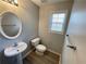 Bathroom featuring a modern sink, toilet, and towel rack plus attractive floors and paint at 4884 Browns Mill Ferry Rd, Lithonia, GA 30038