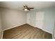 Neutral bedroom features a ceiling fan, two closets, and updated flooring at 4884 Browns Mill Ferry Rd, Lithonia, GA 30038