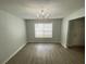 The dining room has laminate floors, a window, and a charming chandelier at 4884 Browns Mill Ferry Rd, Lithonia, GA 30038