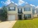 Charming two-story home with a well-manicured lawn and attached garage at 4884 Browns Mill Ferry Rd, Lithonia, GA 30038