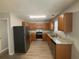 Kitchen with wooden cabinets, stainless steel appliances, and granite countertops at 4884 Browns Mill Ferry Rd, Lithonia, GA 30038