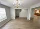 Bright living room features lovely laminate floors, neutral paint, and lots of natural light at 4884 Browns Mill Ferry Rd, Lithonia, GA 30038