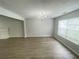 Bright living room features lovely laminate floors, neutral paint, and lots of natural light at 4884 Browns Mill Ferry Rd, Lithonia, GA 30038