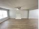 Spacious living room with laminate floors, neutral paint, and a fireplace at 4884 Browns Mill Ferry Rd, Lithonia, GA 30038