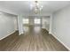 Spacious living room with laminate floors, neutral paint, and a fireplace at 4884 Browns Mill Ferry Rd, Lithonia, GA 30038
